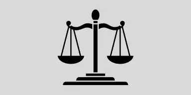 Black silhouette of Lady Justice with balanced scales on a grey background.