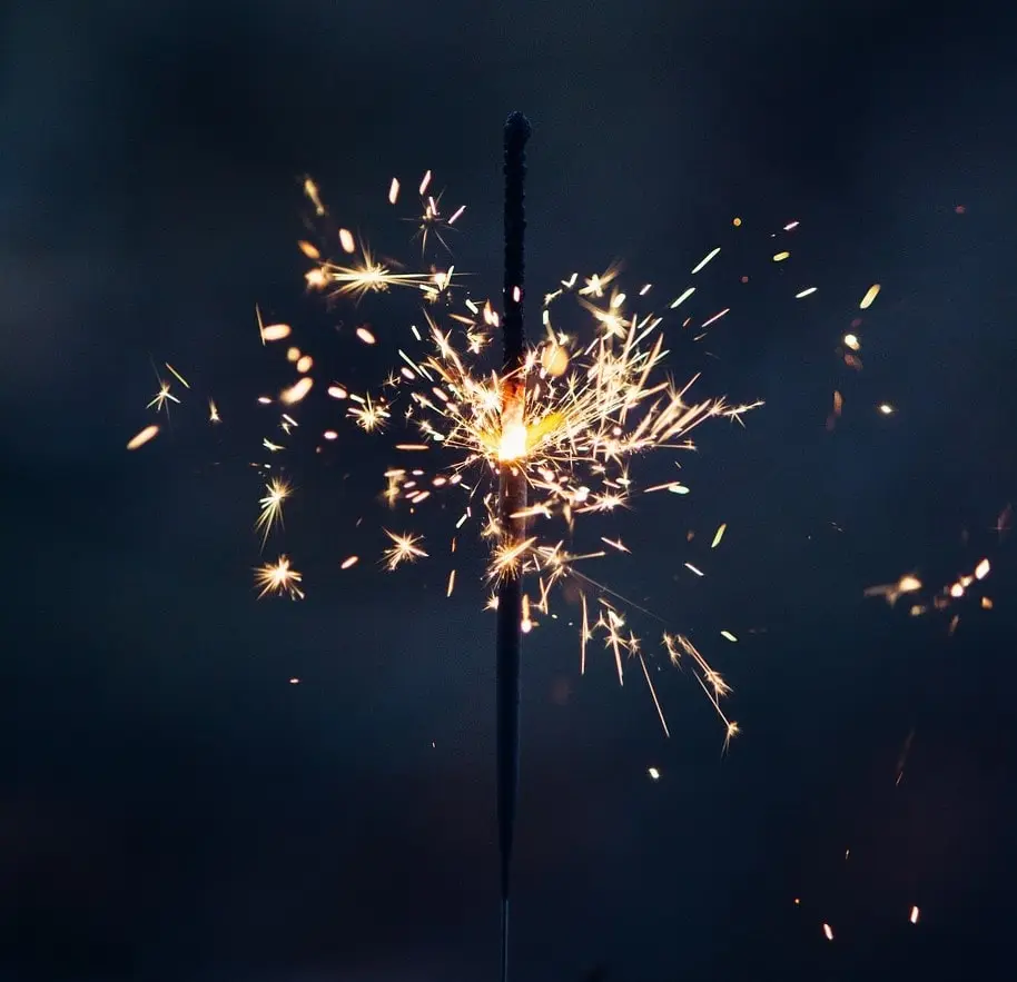 poetry read,A striking close-up image of a single sparkler burning brightly, with golden sparks radiating outward against a dark, blurred background. The sharp contrast highlights the sparkler's vivid energy, making this image perfect for themes of celebration, New Year, festivals, parties, or moments of inspiration and creativity.