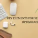 A clean workspace with digital marketing tools and an upward graph symbolizing growth, used as a header image for an article on key elements of SEO. An overhead view of a minimalist desk setup with a keyboard, mouse, earphones, notebook, and an upward-trending graph, representing productivity and growth for an article on key elements of search engine optimization.